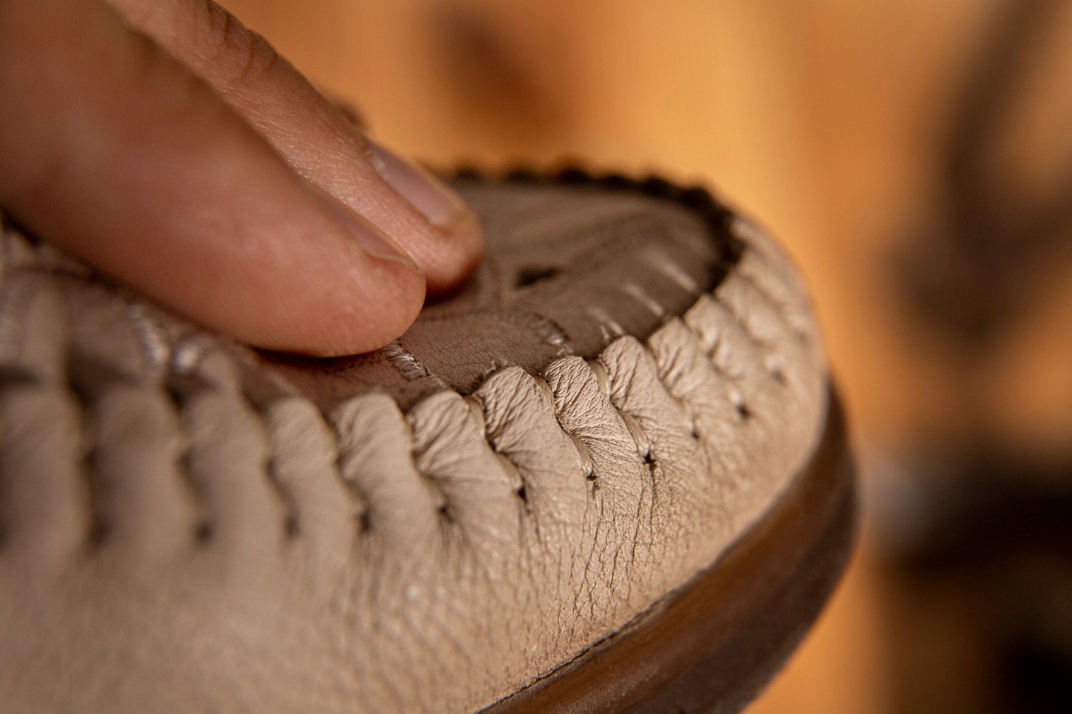 Professional footwear physical testing including sole bonding and material durability checks.